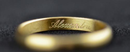 Inside ring engraving of the name Alexandra on a gold wedding ring