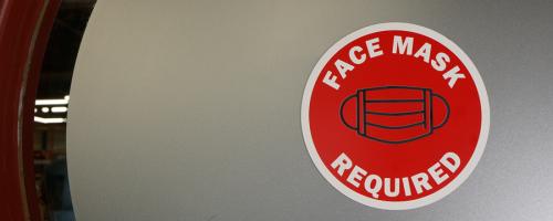 Indoor signage with a face mask requirement symbol made of Gravoply™ 3C engraving material